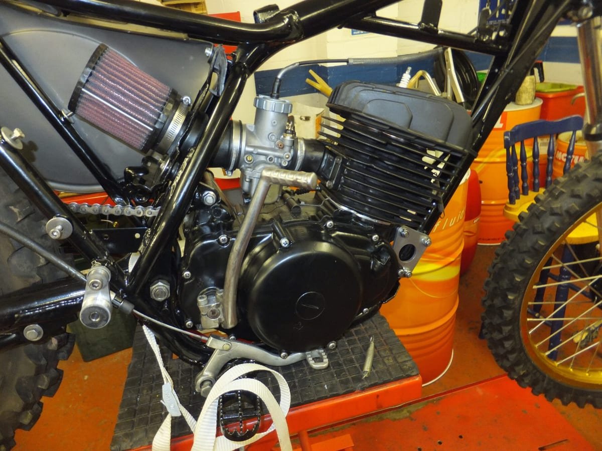Engine, frame and air filter of a classic Honda CR250 on the workshop bench