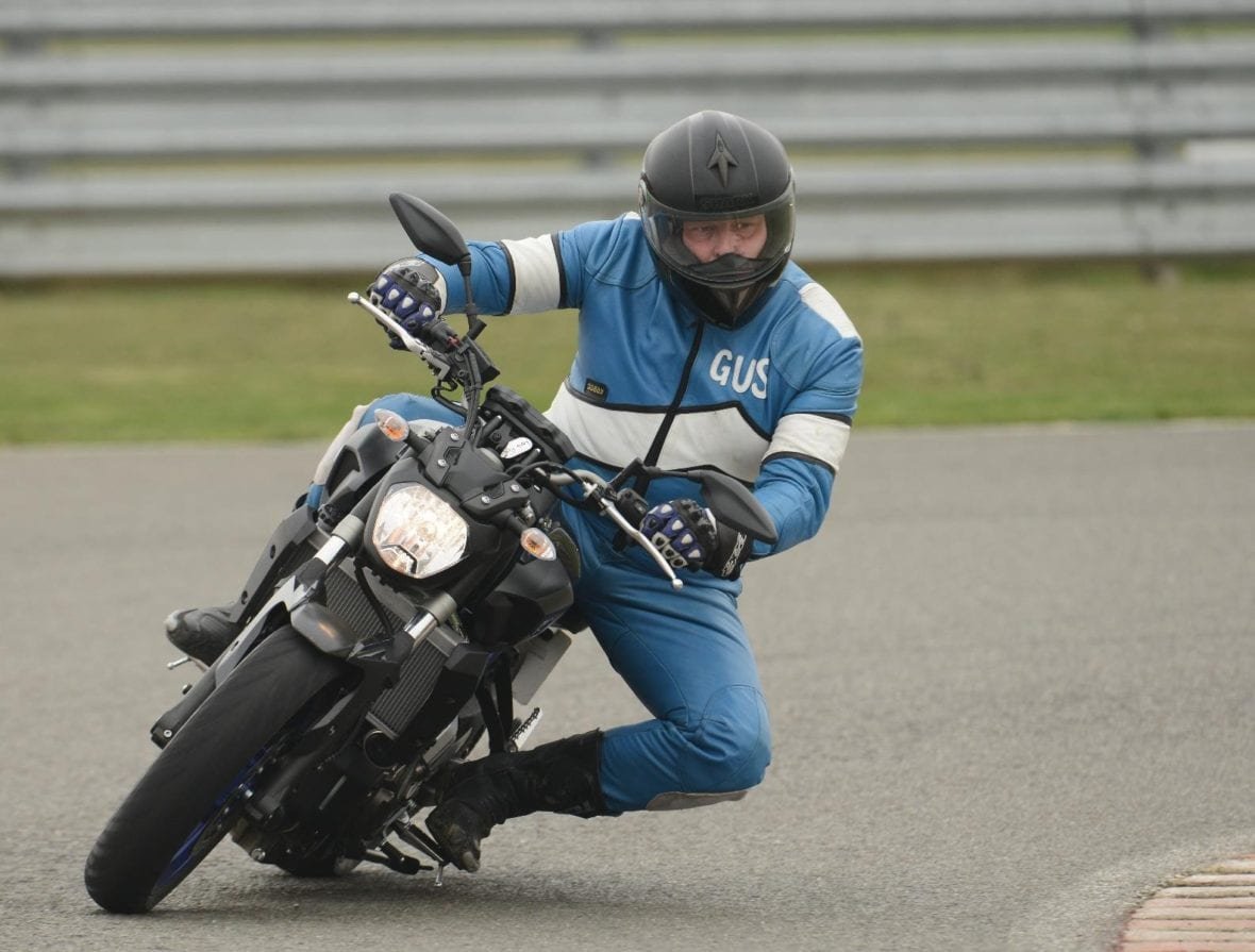 Rider cornering with a knee down on a track day